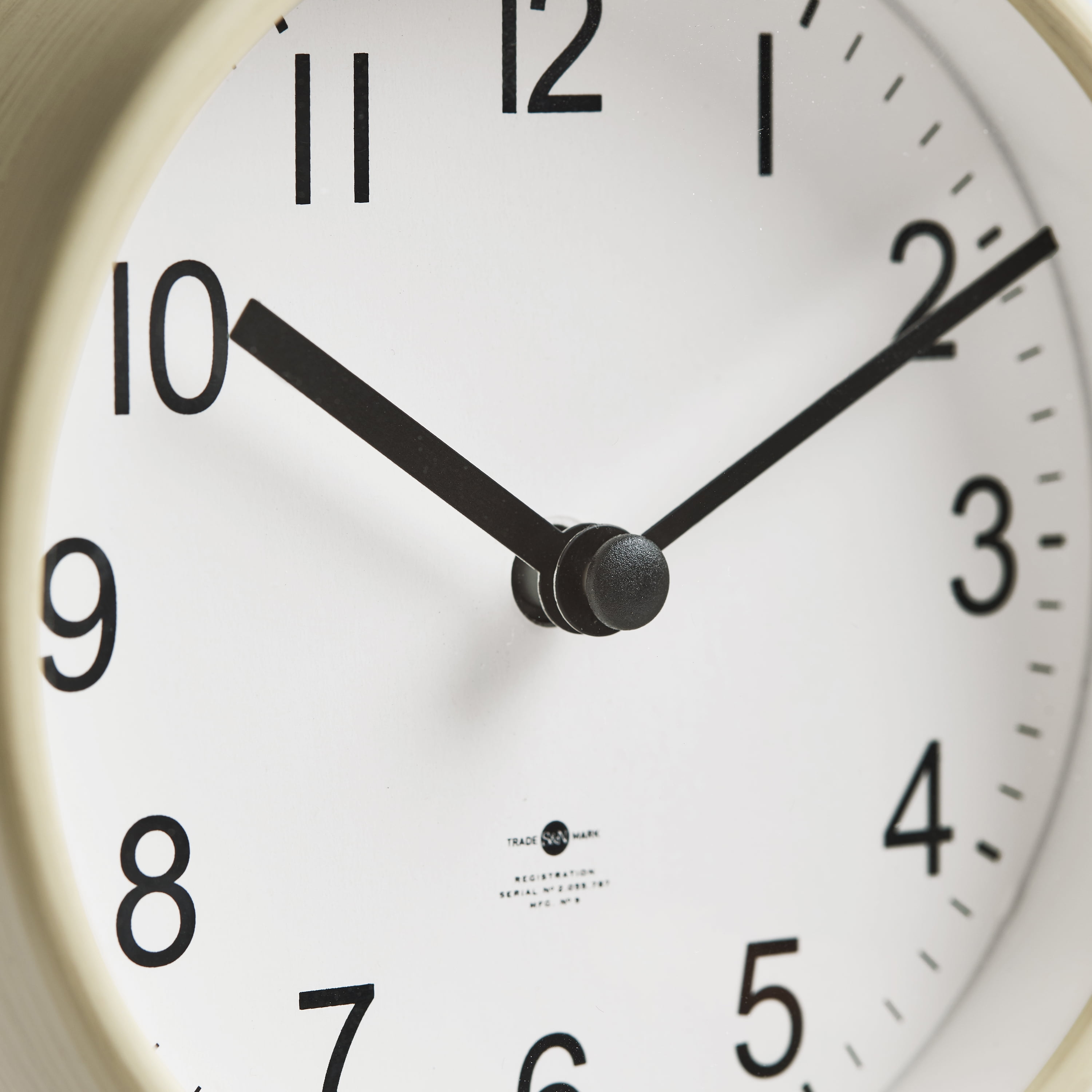 Light brown and black desktop circular analog dial clock with small tray